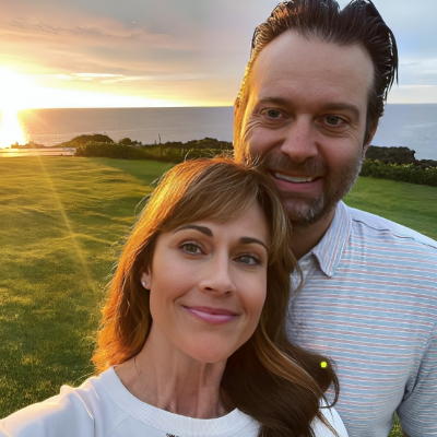 Ryan with his actress wife Nikki, taking a selfie with the sun setting at the back.